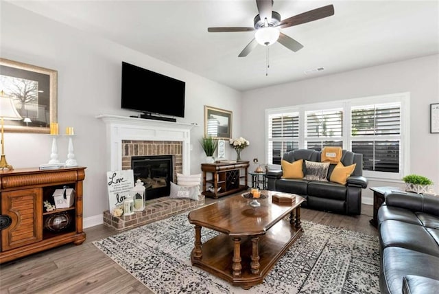 1311 Calgary Lk, Winder, GA 30680 - living area featuring a ceiling fan, wood finished floors, and a fireplace