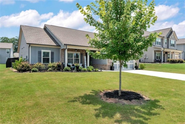 1311 Calgary Lk, Winder, GA 30680 - view of front facade with driveway, a front lawn, brick siding, an attached garage, and board and batten siding