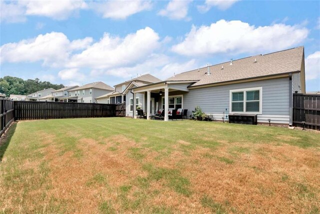 1311 Calgary Lk, Winder, GA 30680 - back of property with a fenced backyard, a patio, ceiling fan, and roof with shingles