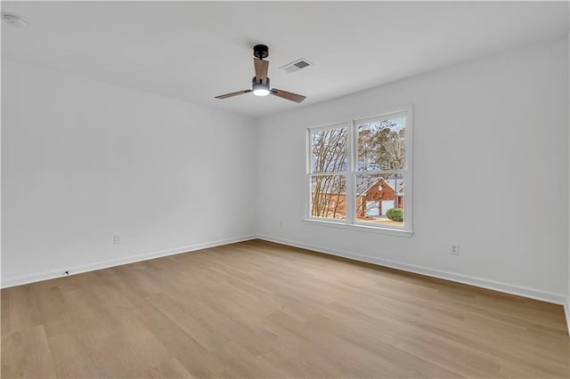 empty room featuring ceiling fan and light hardwood / wood-style floors