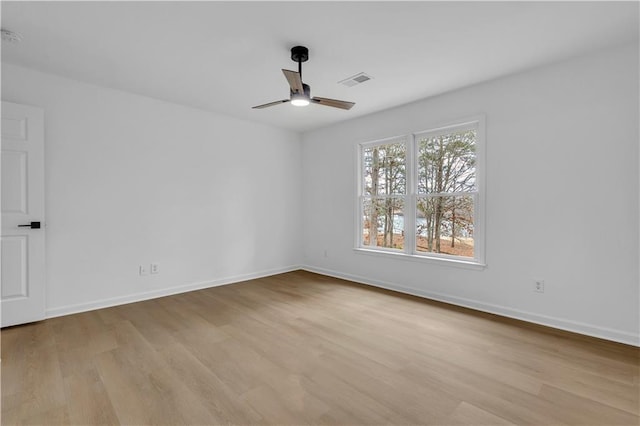 empty room featuring ceiling fan and light hardwood / wood-style flooring