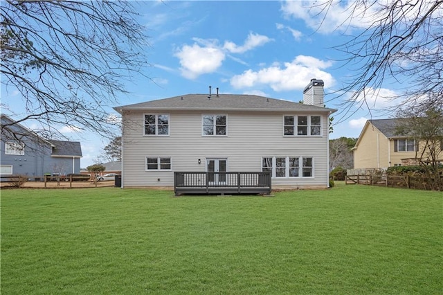 rear view of property featuring a wooden deck and a yard