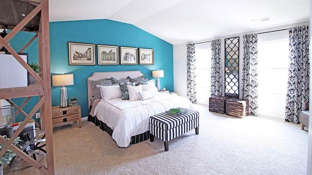 carpeted bedroom with lofted ceiling