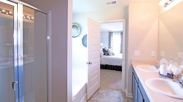 bathroom with vanity and a shower with shower door