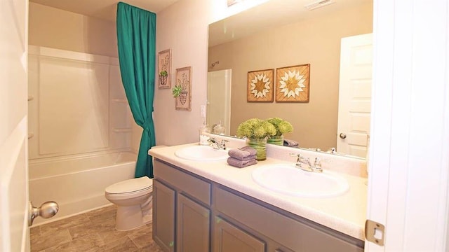 full bathroom featuring washtub / shower combination, vanity, and toilet