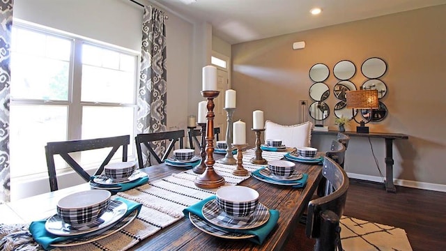 dining space with plenty of natural light and dark hardwood / wood-style flooring