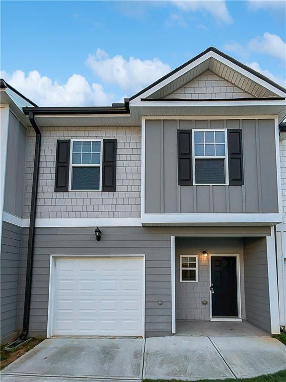 view of front of property with an attached garage and concrete driveway