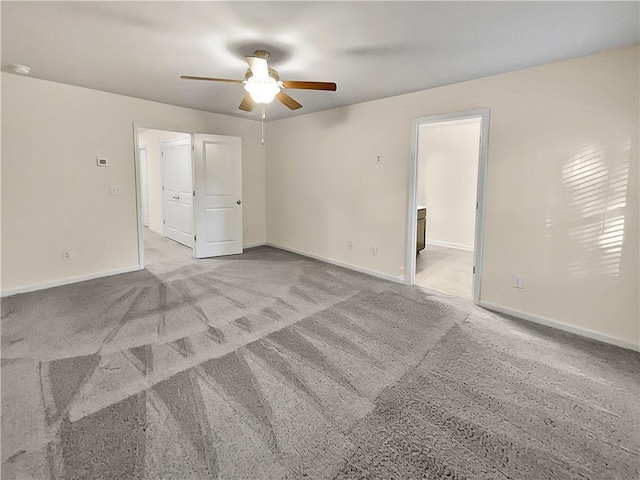 unfurnished room featuring baseboards, a ceiling fan, and carpet
