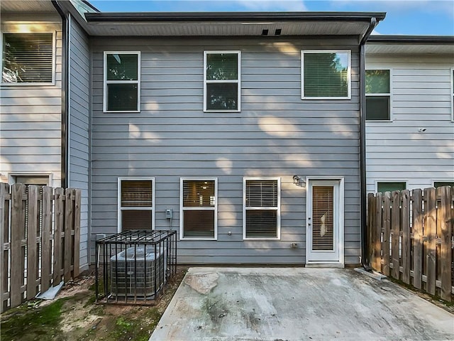 back of house with a patio, central air condition unit, and fence