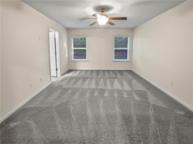 unfurnished room with carpet, baseboards, and a ceiling fan