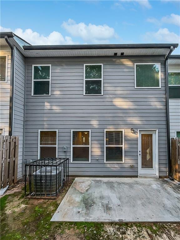rear view of house featuring a patio area and fence