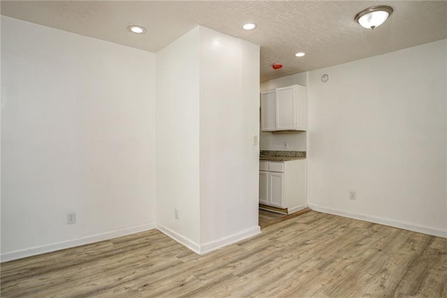 2437 Clarissa Dr NW, Atlanta, GA 30318 - spare room featuring light wood finished floors, recessed lighting, and a textured ceiling