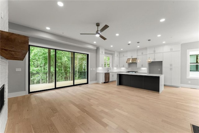 1420 Coretta Bnd, Atlanta, GA 30318 - kitchen featuring under cabinet range hood, stainless steel dishwasher, white cabinetry, light countertops, and ceiling fan
