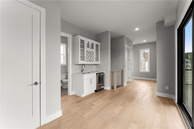 1420 Coretta Bnd, Atlanta, GA 30318 - indoor wet bar with baseboards, wine cooler, light wood-style flooring, plenty of natural light, and recessed lighting
