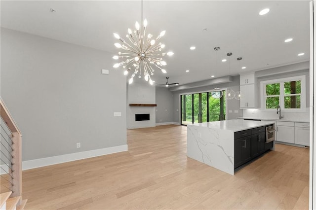 1420 Coretta Bnd, Atlanta, GA 30318 - kitchen with a sink, a chandelier, a center island, light wood finished floors, and open floor plan