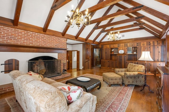 living room featuring high vaulted ceiling, wood-type flooring, beam ceiling, and a chandelier