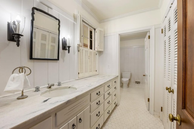 bathroom with crown molding, toilet, tile patterned flooring, and vanity