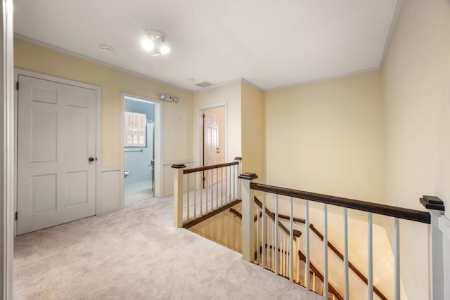 hallway featuring light carpet and crown molding