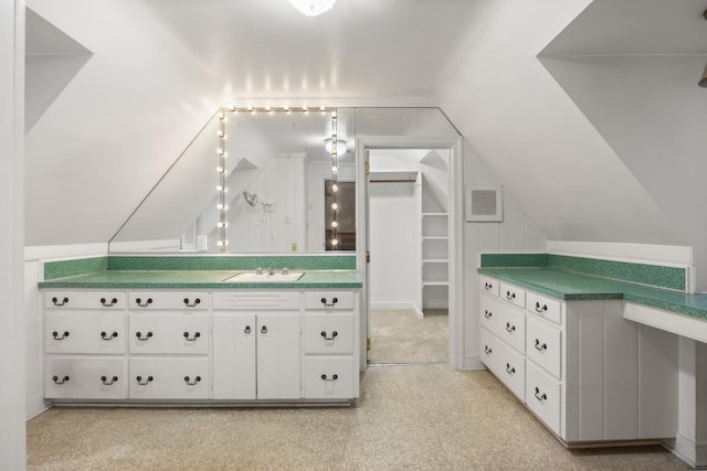 interior space featuring sink, light colored carpet, and vaulted ceiling