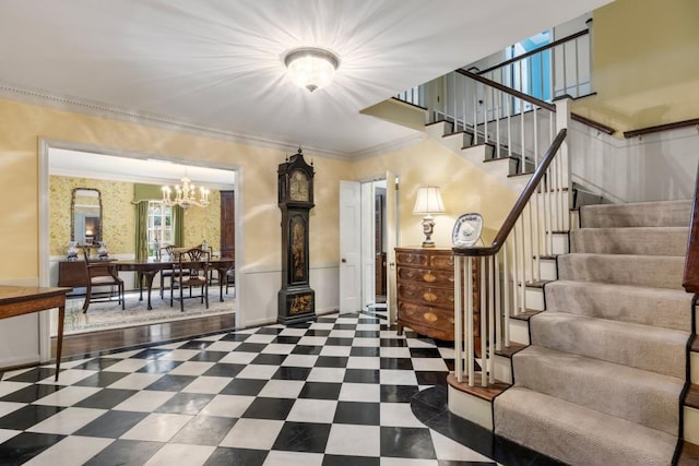 entryway featuring a notable chandelier and ornamental molding