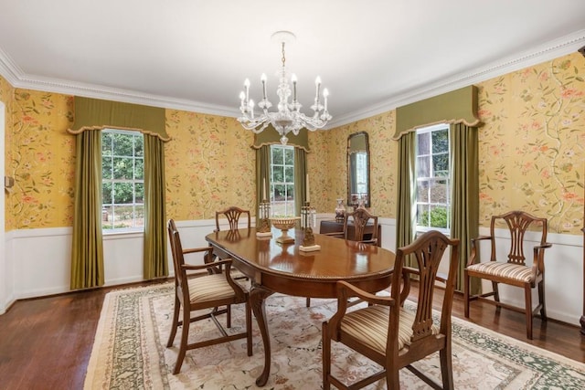 dining area with crown molding, dark hardwood / wood-style floors, and an inviting chandelier