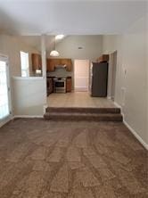1752 Spring Hill Cv, Lithonia, GA 30058 - unfurnished living room with baseboards and carpet flooring
