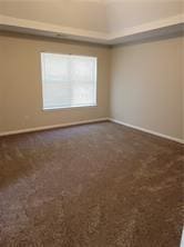 1752 Spring Hill Cv, Lithonia, GA 30058 - spare room featuring baseboards and dark carpet