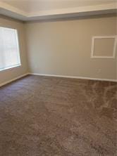 1752 Spring Hill Cv, Lithonia, GA 30058 - spare room featuring dark colored carpet and baseboards