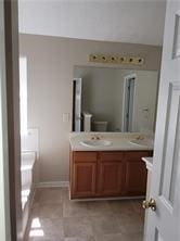 1752 Spring Hill Cv, Lithonia, GA 30058 - bathroom featuring double vanity and baseboards
