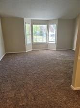 1752 Spring Hill Cv, Lithonia, GA 30058 - carpeted spare room featuring baseboards