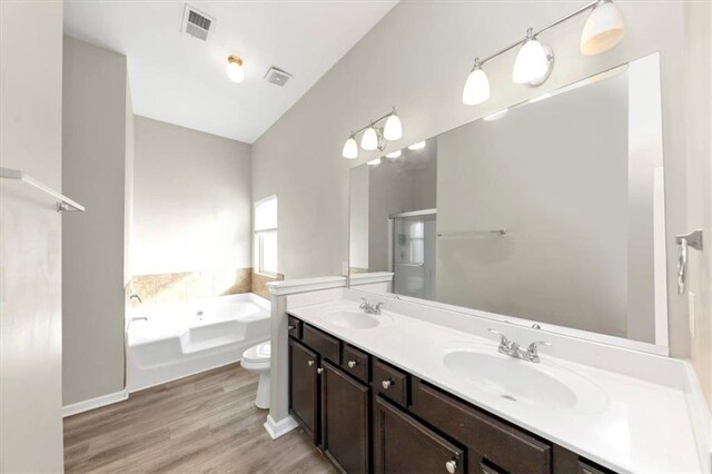 bathroom with wood-type flooring and separate shower and tub