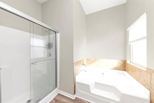 bathroom featuring separate shower and tub and hardwood / wood-style floors