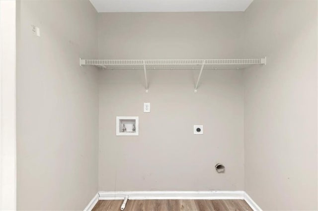 clothes washing area featuring washer hookup, hardwood / wood-style floors, and electric dryer hookup