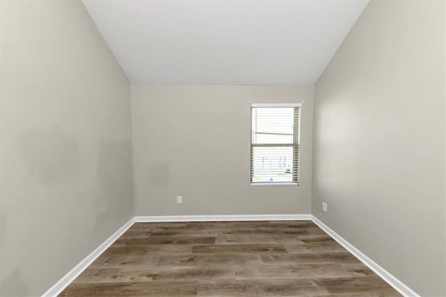 unfurnished room with vaulted ceiling and hardwood / wood-style floors