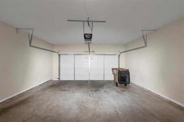 garage featuring electric panel, a garage door opener, and gas water heater