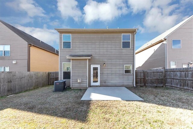 back of house featuring a patio, central AC unit, and a lawn