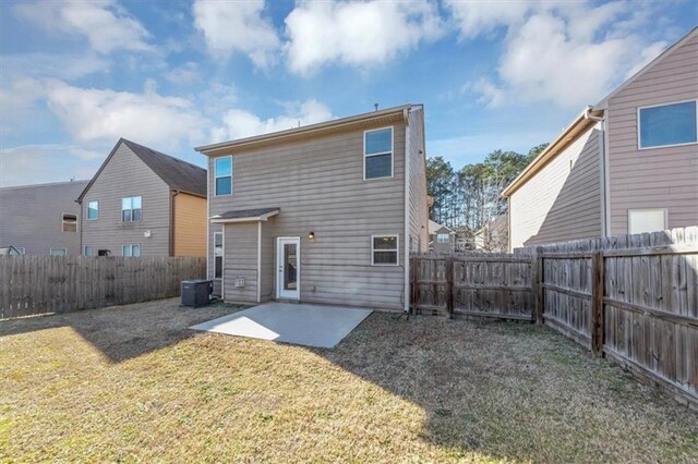 rear view of house featuring a patio, central air condition unit, and a lawn