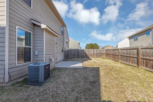 rear view of house featuring a patio area, cooling unit, and a lawn