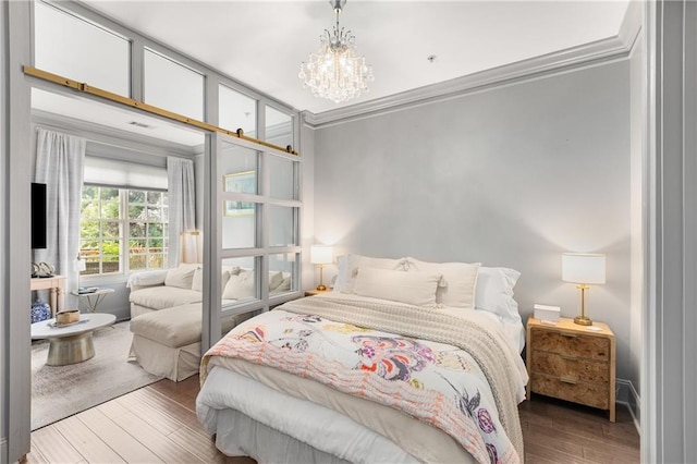 1055 Piedmont Ave NE Unit 106, Atlanta, GA 30309 - bedroom featuring wood finished floors, a chandelier, and crown molding