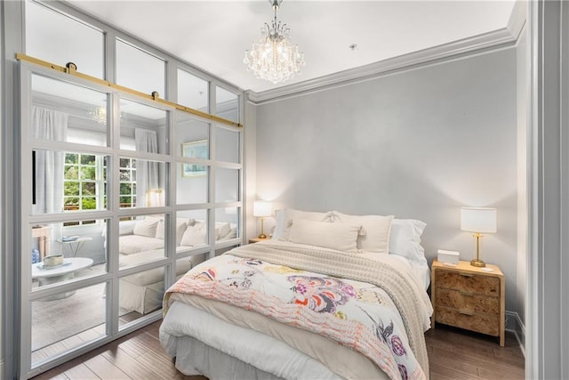 1055 Piedmont Ave NE Unit 106, Atlanta, GA 30309 - bedroom with a chandelier, wood finished floors, and crown molding