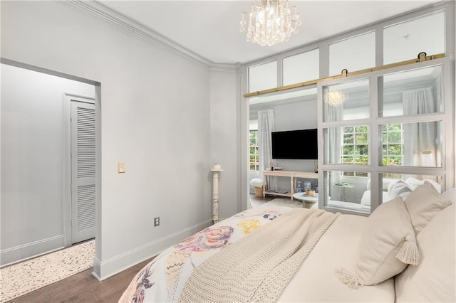 1055 Piedmont Ave NE Unit 106, Atlanta, GA 30309 - bedroom featuring dark wood finished floors, a chandelier, and ornamental molding