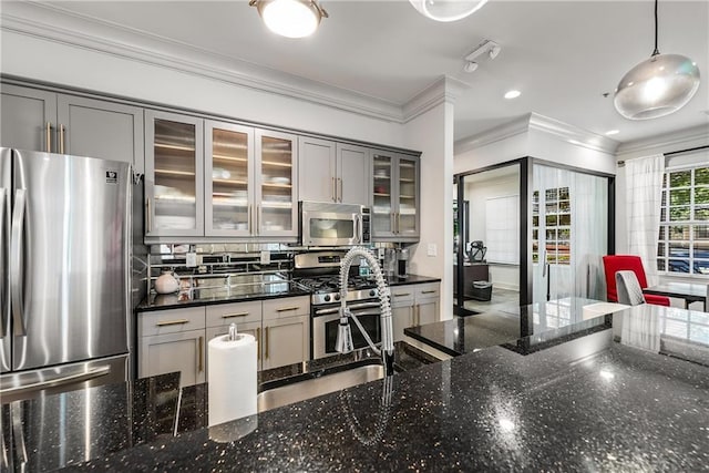 1055 Piedmont Ave NE Unit 106, Atlanta, GA 30309 - kitchen with stainless steel appliances, gray cabinetry, ornamental molding, dark stone counters, and decorative light fixtures