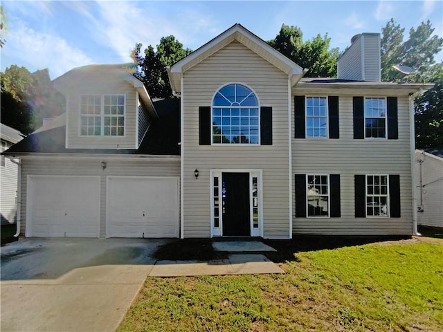 view of front of house with a garage and a front yard