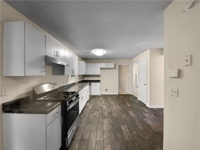 kitchen with white cabinets, stainless steel gas range oven, a textured ceiling, and dark hardwood / wood-style floors