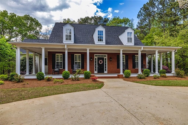 20 Jasmine Ct, Newnan, GA 30265 - view of front facade featuring brick siding, a porch, concrete driveway, and roof with shingles