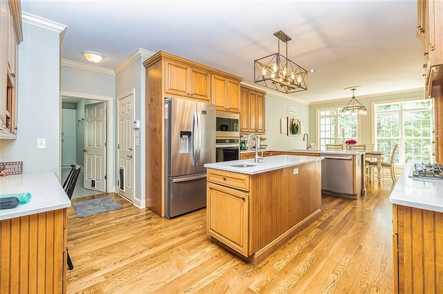 20 Jasmine Ct, Newnan, GA 30265 - kitchen with appliances with stainless steel finishes, a kitchen island with sink, ornamental molding, light wood finished floors, and light countertops