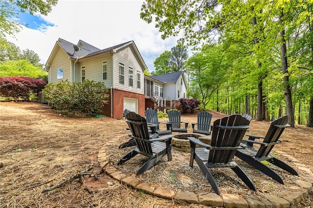 20 Jasmine Ct, Newnan, GA 30265 - rear view of house with an outdoor fire pit and an attached garage