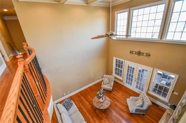 interior space with ornamental molding, french doors, wood finished floors, and visible vents