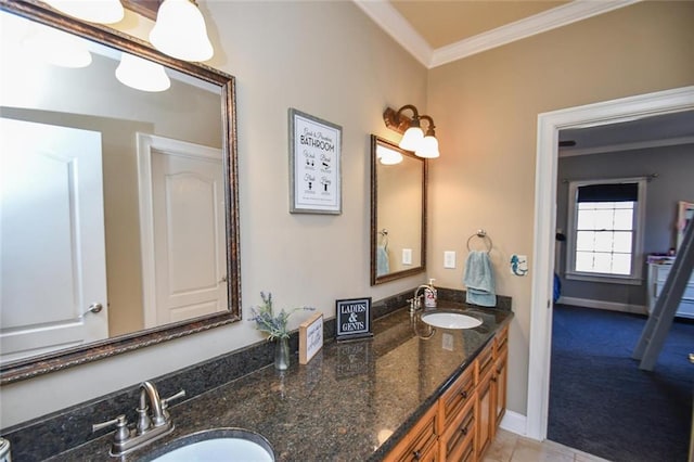 full bathroom featuring baseboards, double vanity, a sink, and crown molding