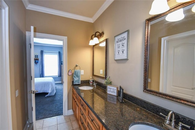 ensuite bathroom featuring double vanity, ornamental molding, a sink, and tile patterned floors